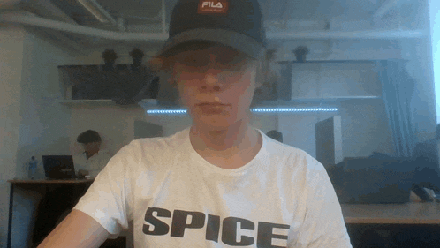 a man wearing a white shirt that says spice