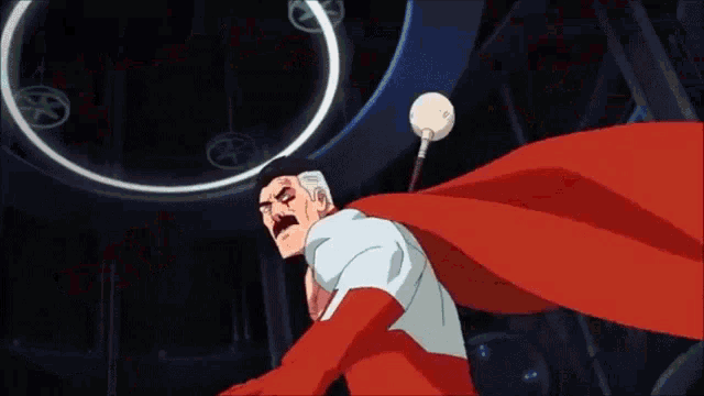 a man in a superhero costume with a red cape is standing in a room .