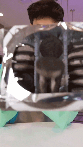 a man is looking through a clear plastic bag