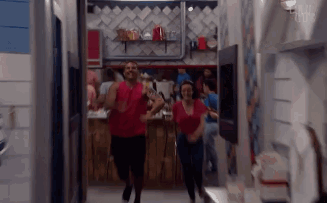 a man and a woman are dancing in a hallway with the words full circle visible on the wall
