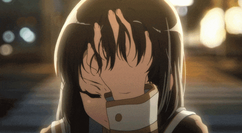 a girl covering her face with her hands in a blurry picture