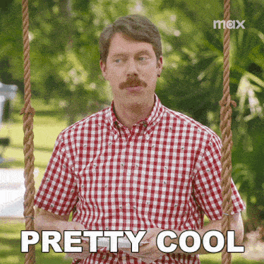 a man with a mustache is sitting on a swing and says " pretty cool "