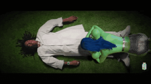 a man in a white robe is laying on a green mermaid