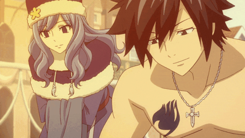 a man and a woman are standing next to each other and the man has a fairy tail tattoo on his chest