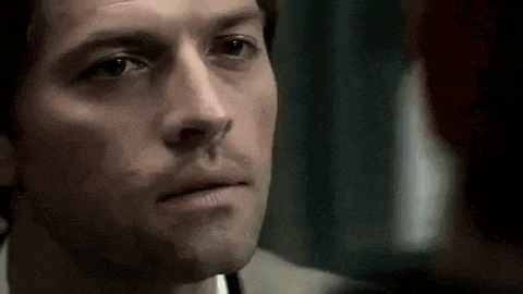 a close up of a man 's face with a slight smile on his face .