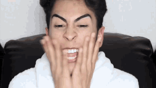 a man in a white robe is making a funny face
