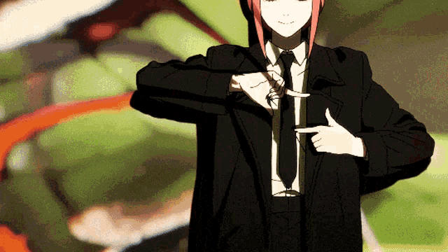 a girl in a suit and tie is pointing at herself