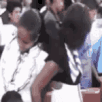 a group of people are sitting in a room and a man is carrying another man on his back .