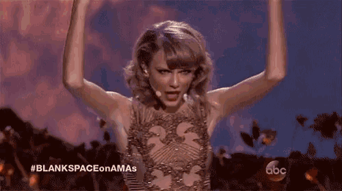 a woman stands in front of a microphone with her arms in the air and the words abc on the bottom