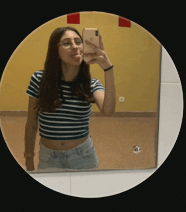 a woman taking a picture of herself in a mirror with her phone