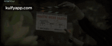 a person holding a clapper board that says haathi mere saathi on it