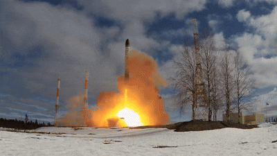 a rocket is being launched in the snow with a blue sky in the background