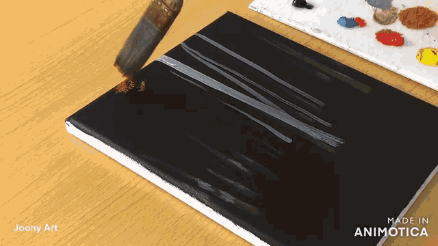 joany art shows a person painting on a black canvas