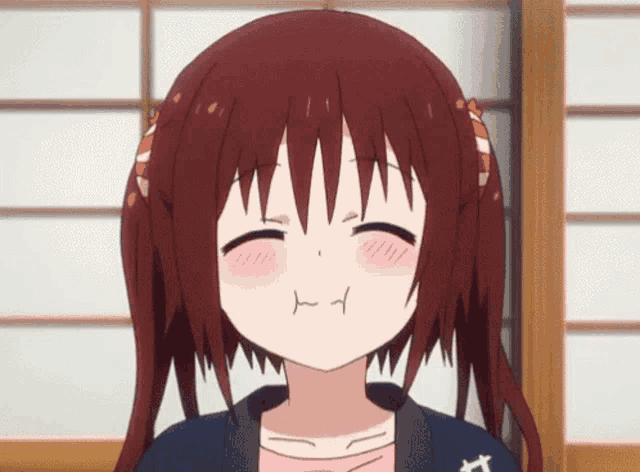a close up of a girl with red hair making a face