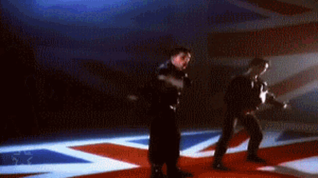 a person is walking on a red , white and blue floor .