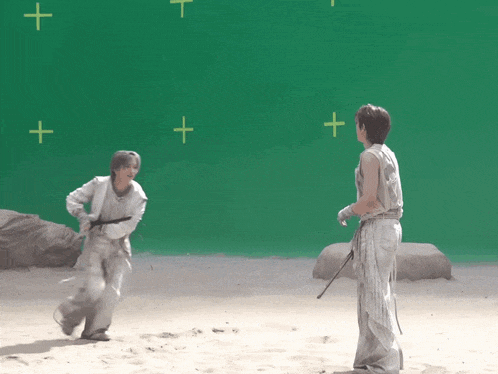 a couple of people standing in front of a green screen