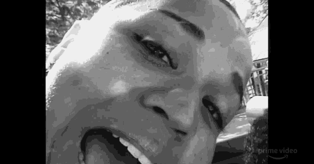 a black and white photo of a person 's face with their mouth open .