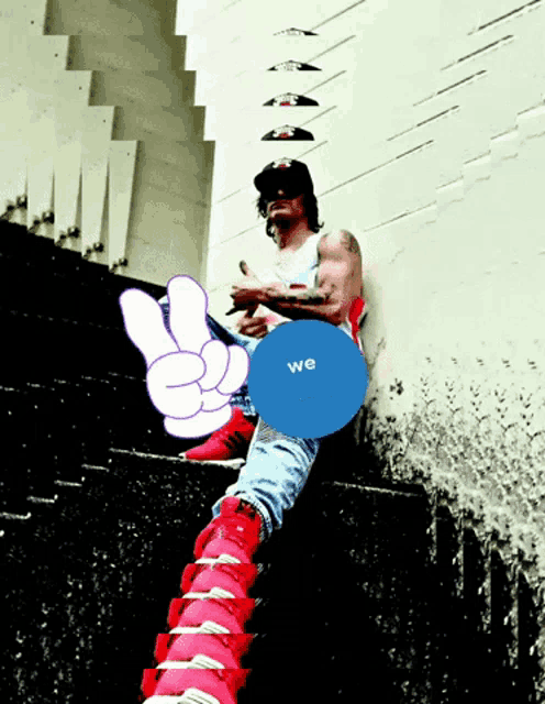 a man is sitting on a set of stairs with a blue circle that says we