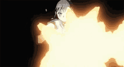 a person is holding a fireball in their hand in a dark room .