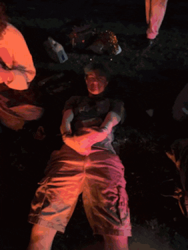 a man laying on the ground wearing a shirt that says ' fox ' on it