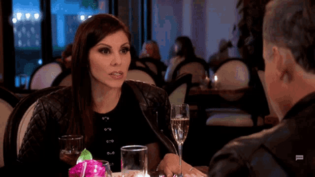 a woman is sticking her tongue out while sitting at a table with a man