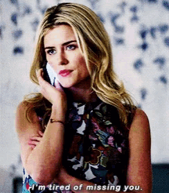 a blonde woman is talking on a cell phone and says i 'm tired of missing you
