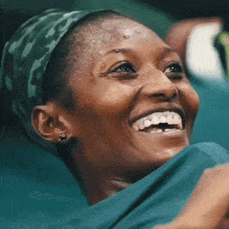 a close up of a woman 's face with a green headband on