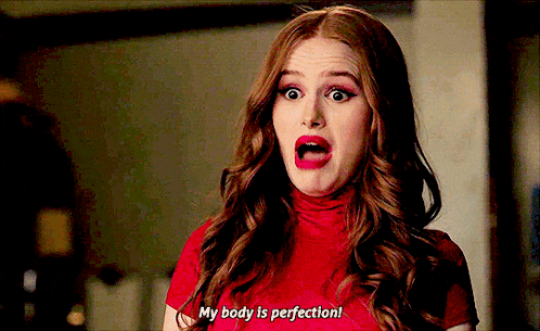 a woman in a red shirt is making a face and saying `` my body is perfection '' .
