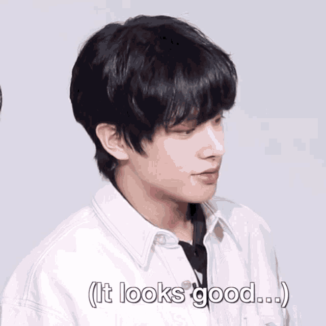 a close up of a person 's face with the words " it looks good " next to it