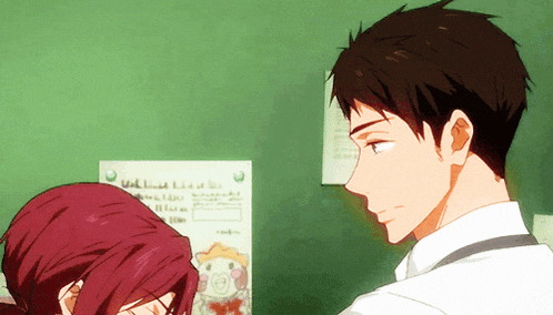 a man and a woman are looking at each other in front of a green board