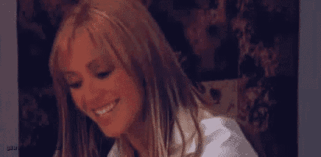 a close up of a woman 's face with long blonde hair .