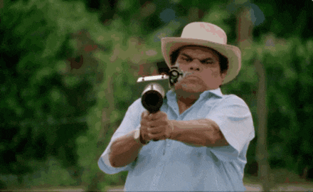 a man in a cowboy hat is pointing a gun at something