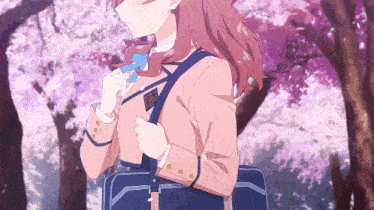 a girl in a pink school uniform is carrying a blue briefcase