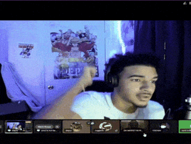 a man wearing headphones giving a high five in front of a poster that says one piece