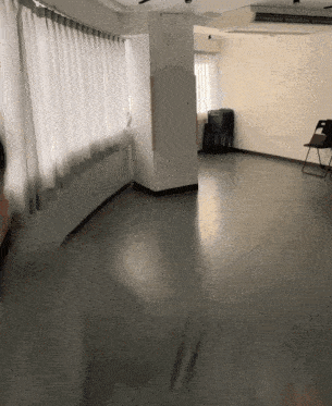a large empty room with a chair and a window