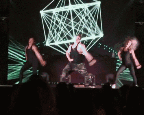 a group of people are dancing on a stage