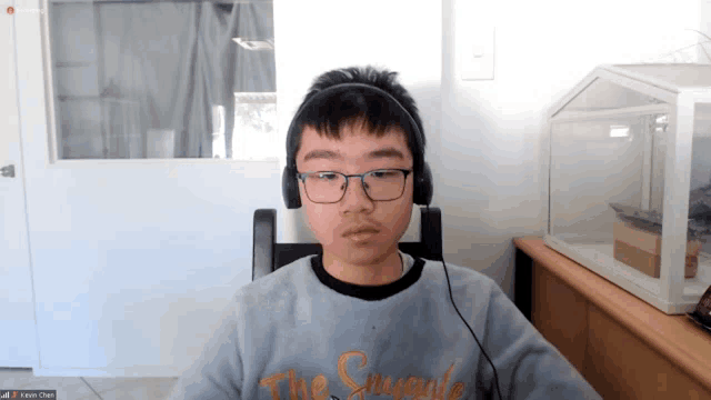 a young boy wearing headphones and a sweatshirt that says the struggles