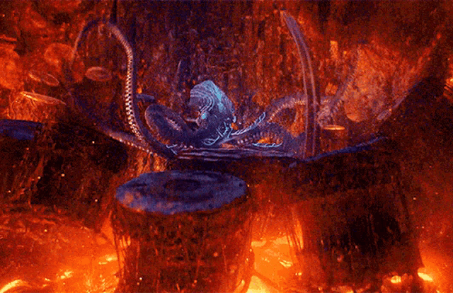 a glowing octopus is sitting on top of a rock in a cave