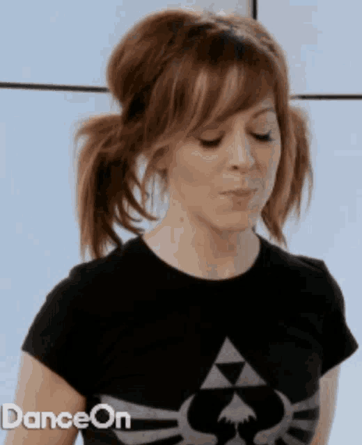 a woman wearing a black t-shirt with a zelda logo on it