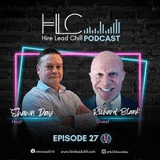 two men are standing next to each other in front of a brick wall in a podcast .
