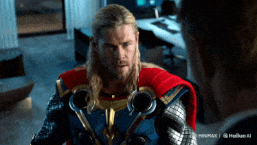 a man in a thor costume is talking to another man in a suit