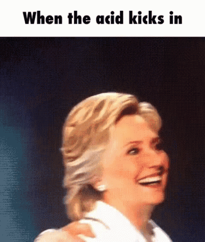 a woman is smiling and laughing with the words when the acid kicks in .