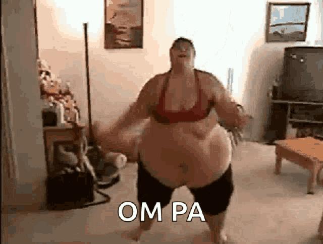 a very fat woman is dancing in a living room with the word om pa written on the floor