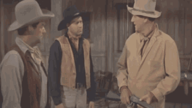 a man in a cowboy hat is standing next to a woman