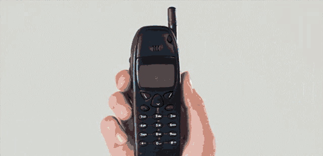 a hand is holding a cell phone with the words jadul amat smartphone kali written below it
