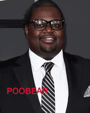 a man in a suit and tie with the word poobear written in red