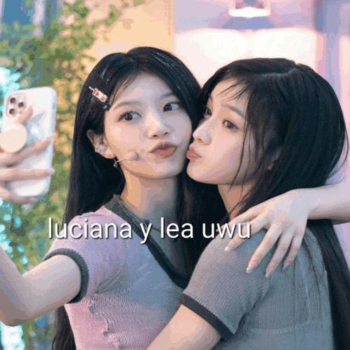 two girls are taking a selfie with the words luciana y lea uwu below them