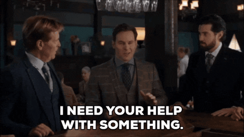 a man in a suit says " i need your help with something " in front of two other men