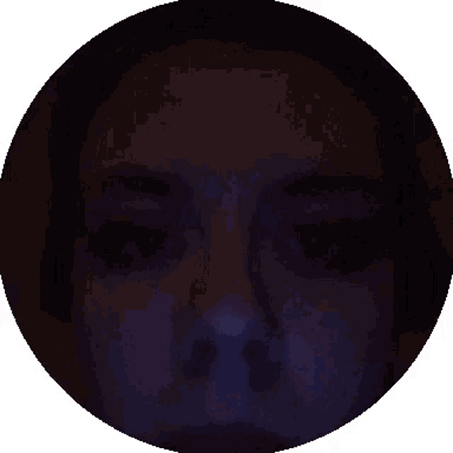 a close up of a person 's face in a dark room
