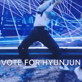 a person is dancing on a stage with the words `` vote for hyunjun '' written on the bottom .
